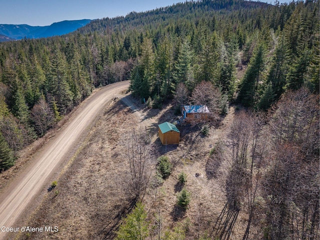 drone / aerial view with a view of trees and a mountain view