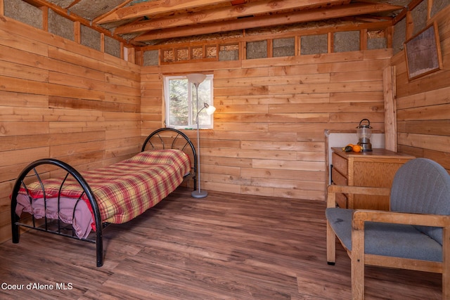 bedroom with wooden walls and wood finished floors