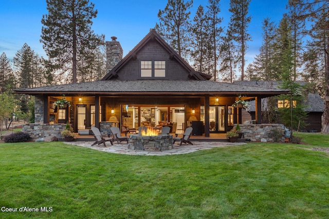 2623 E Old Barn Ct, Harrison, ID 83833 - back of property featuring a chimney, a fire pit, a yard, and a patio area