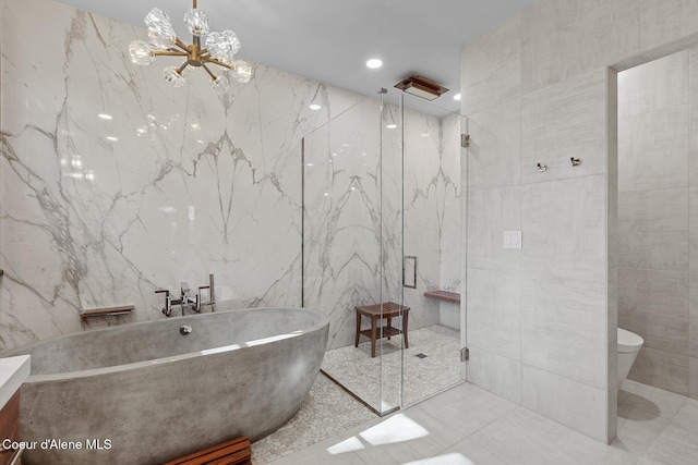 2623 E Old Barn Ct, Harrison, ID 83833 - full bath with toilet, a marble finish shower, a freestanding bath, tile walls, and an inviting chandelier