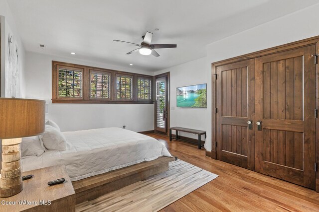2623 E Old Barn Ct, Harrison, ID 83833 - bedroom featuring multiple windows, light wood-type flooring, recessed lighting, and a ceiling fan