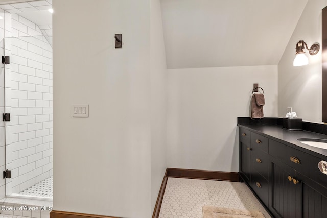 2623 E Old Barn Ct, Harrison, ID 83833 - bathroom featuring a stall shower, vanity, lofted ceiling, tile patterned flooring, and baseboards