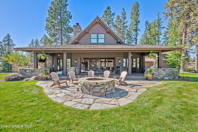 2623 E Old Barn Ct, Harrison, ID 83833 - back of house featuring a chimney, a fire pit, a yard, and a patio area