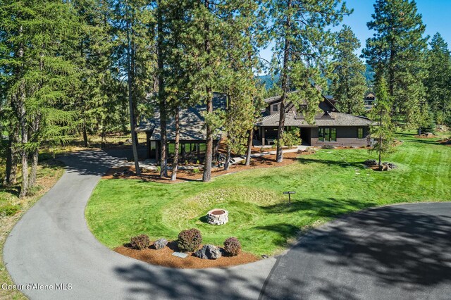 2623 E Old Barn Ct, Harrison, ID 83833 - view of front of property featuring a front lawn, a fire pit, and driveway