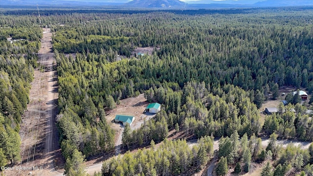 bird's eye view with a forest view and a mountain view