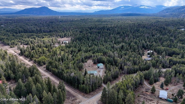 bird's eye view featuring a wooded view and a mountain view