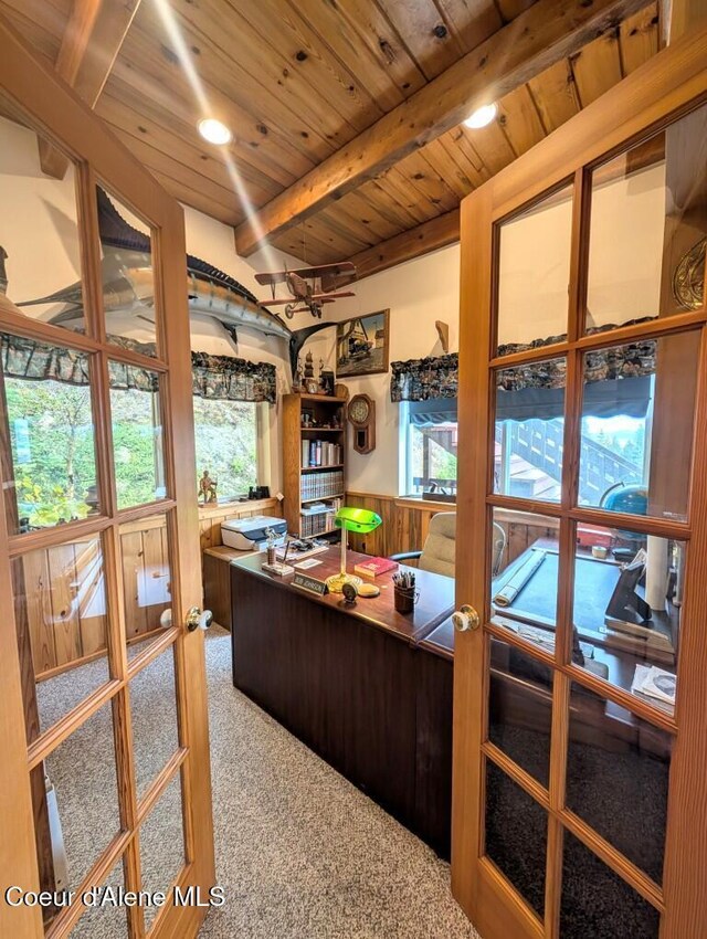 carpeted office featuring french doors, beamed ceiling, wainscoting, and wood ceiling