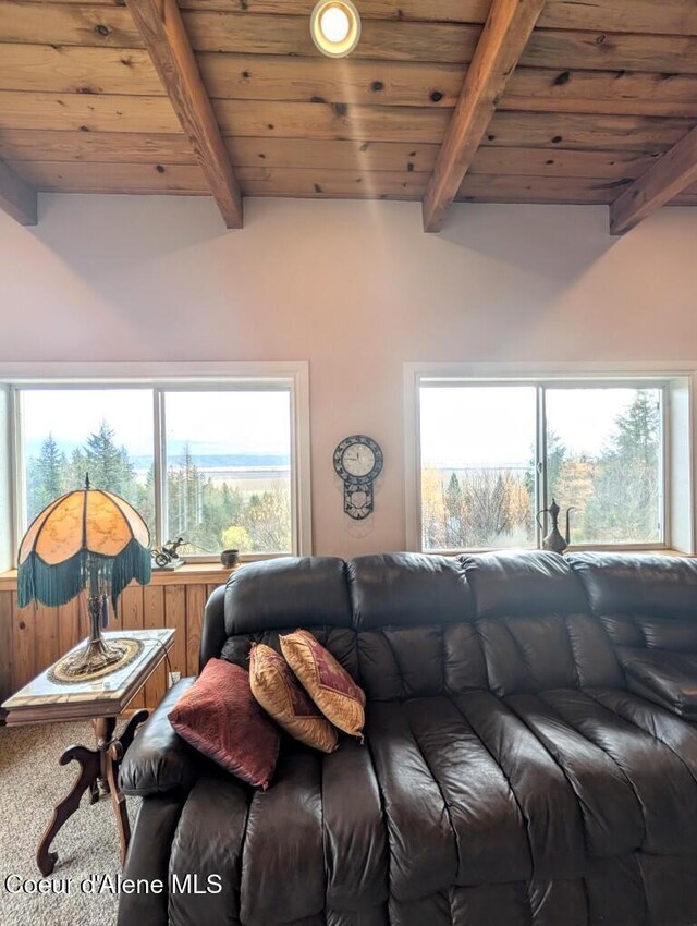 carpeted living room with wood ceiling and beamed ceiling