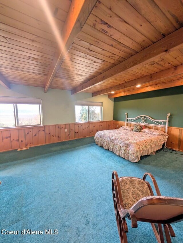 bedroom featuring wooden walls, beam ceiling, carpet, a wainscoted wall, and wooden ceiling