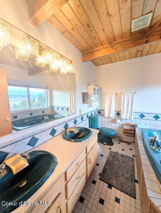 full bathroom with a chandelier, a sink, and tile patterned flooring