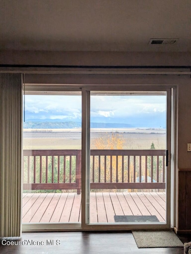 doorway to outside featuring visible vents and wood finished floors