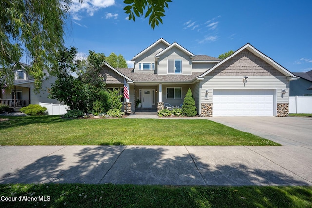 687 E Round Up Cir, Hayden, ID 83835 - view of front facade featuring a garage, concrete driveway, stone siding, and covered porch