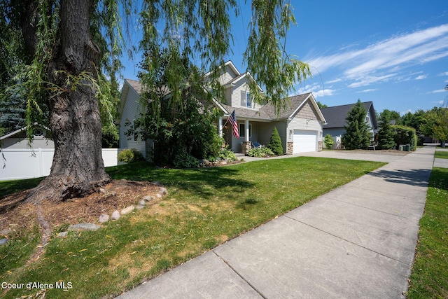 687 E Round Up Cir, Hayden, ID 83835 - view of property hidden behind natural elements with concrete driveway, a garage, and a porch