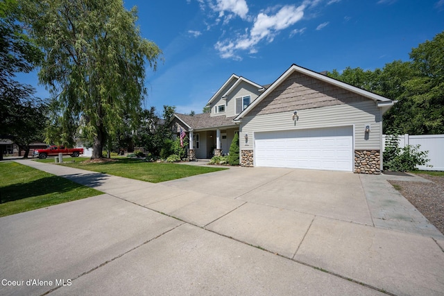 687 E Round Up Cir, Hayden, ID 83835 - view of front facade with stone siding, a garage, driveway, and a porch