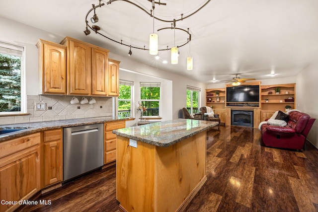 687 E Round Up Cir, Hayden, ID 83835 - kitchen with stainless steel dishwasher, a center island, a fireplace, and dark wood-style flooring
