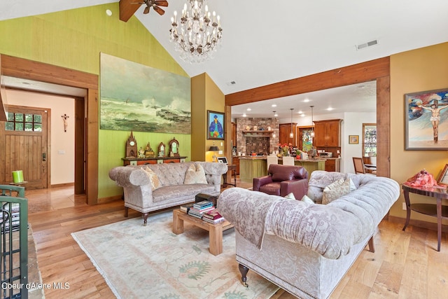 1990 S Gateway Ranch Rd, Coeur Dalene, ID 83814 - living area featuring ceiling fan with notable chandelier, high vaulted ceiling, beamed ceiling, light wood-type flooring, and visible vents