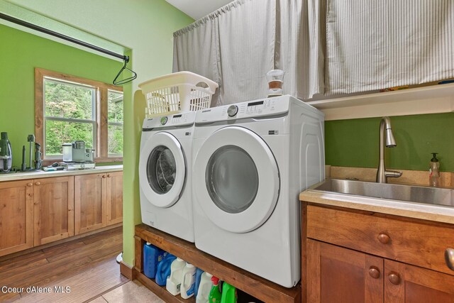 1990 S Gateway Ranch Rd, Coeur Dalene, ID 83814 - washroom with a sink, separate washer and dryer, and wood finished floors
