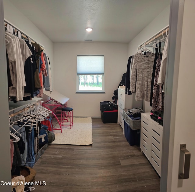 walk in closet featuring dark wood-style floors and visible vents