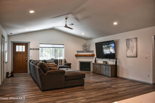 living area with lofted ceiling, recessed lighting, dark wood-style flooring, a ceiling fan, and a fireplace