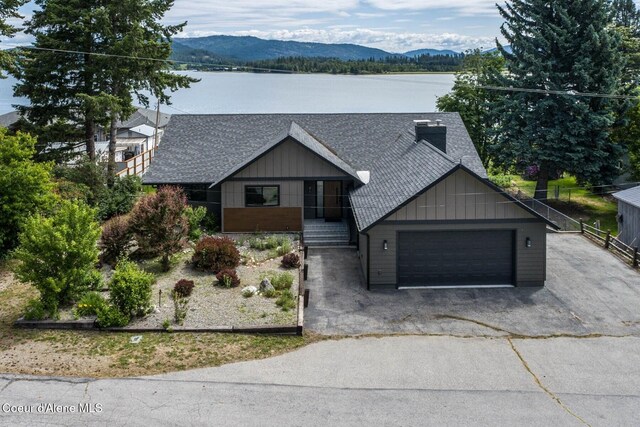 475 Campbell Point Rd, Laclede, ID 83841 - view of front facade featuring a shingled roof, a mountain view, a garage, driveway, and board and batten siding