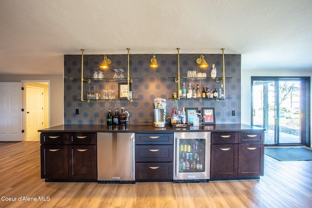 475 Campbell Point Rd, Laclede, ID 83841 - indoor bar with wine cooler, light wood finished floors, wallpapered walls, and a textured ceiling