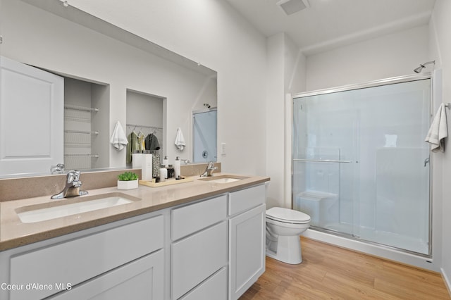 5181 E Aquila Ave, Post Falls, ID 83854 - full bathroom with wood finished floors, visible vents, a sink, and a stall shower
