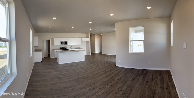 5181 E Aquila Ave, Post Falls, ID 83854 - kitchen featuring a kitchen island with sink, appliances with stainless steel finishes, open floor plan, white cabinetry, and dark wood-type flooring