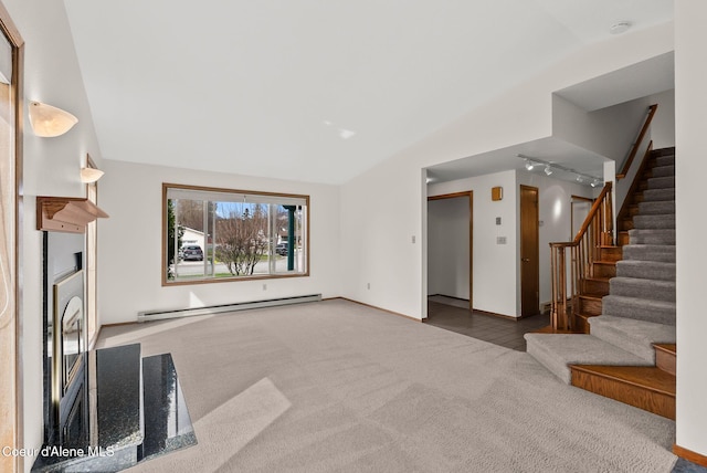 unfurnished living room with baseboards, rail lighting, carpet floors, stairs, and a baseboard radiator