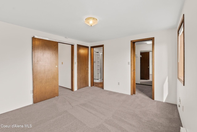 unfurnished bedroom with two closets and carpet floors