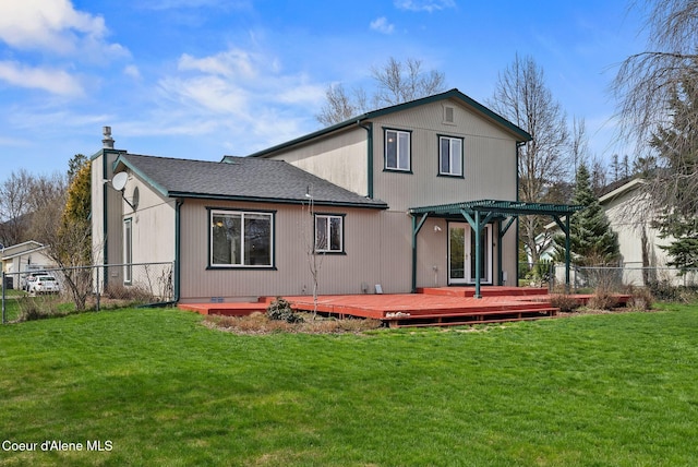 rear view of property with a pergola, fence, and a lawn