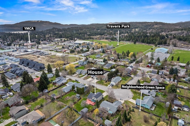 bird's eye view with a wooded view, a mountain view, and a residential view
