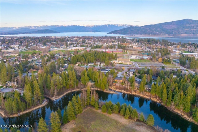birds eye view of property featuring a water and mountain view
