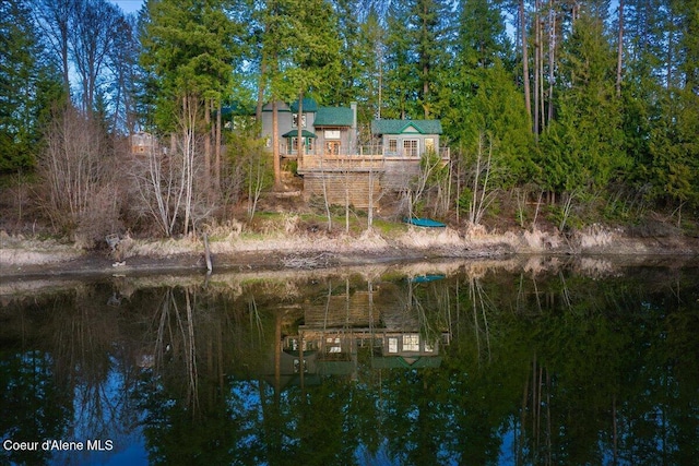 exterior space with a deck with water view and stairs