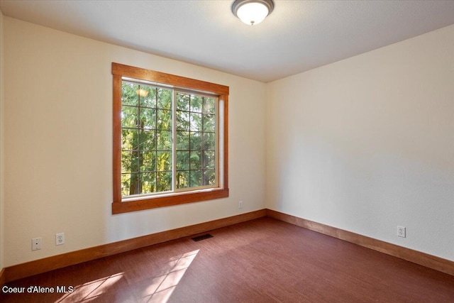 unfurnished room with carpet flooring, baseboards, and visible vents