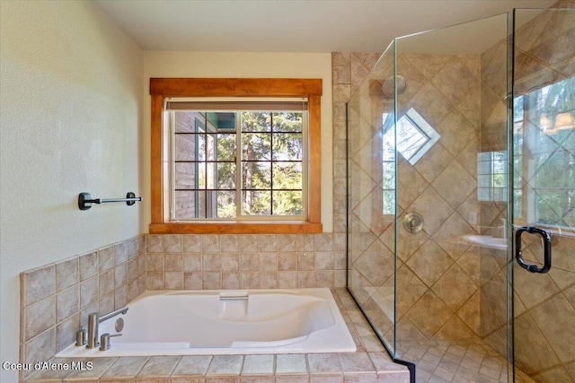full bathroom with a shower stall and a bath