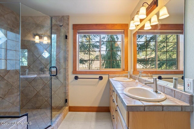 full bath with a sink, a stall shower, and a healthy amount of sunlight