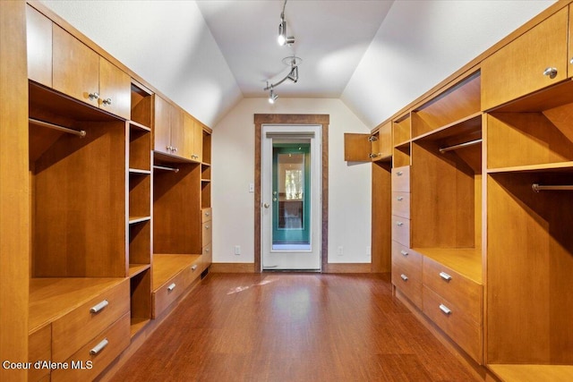 mudroom with dark wood-type flooring, track lighting, baseboards, and lofted ceiling