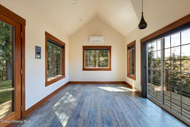 unfurnished sunroom featuring a wall unit AC and a healthy amount of sunlight