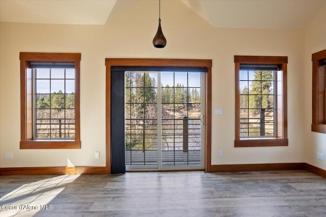 doorway to outside with baseboards, wood finished floors, and a healthy amount of sunlight