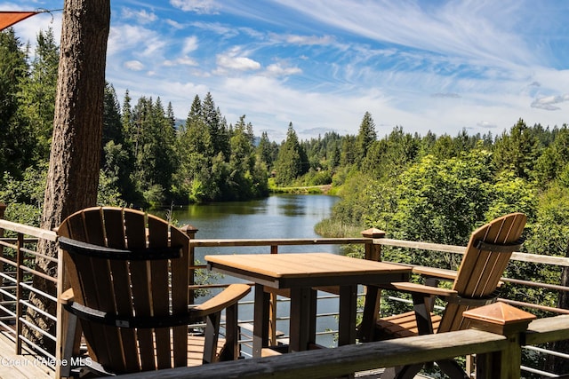 wooden deck with a water view and a view of trees