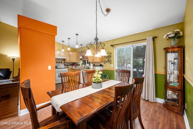 2790 W Versailles Dr, Coeur Dalene, ID 83815 - dining space with an inviting chandelier, lofted ceiling, baseboards, and wood finished floors