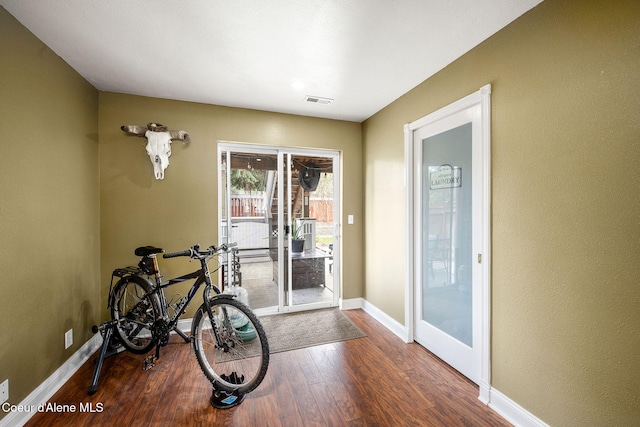 2790 W Versailles Dr, Coeur Dalene, ID 83815 - doorway to outside featuring visible vents, wood finished floors, and baseboards