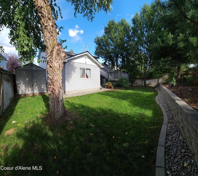2790 W Versailles Dr, Coeur Dalene, ID 83815 - view of yard featuring an outbuilding, a fenced backyard, and a storage unit