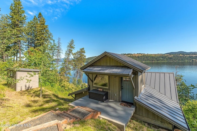 1967 W Cottonwood Rd, Worley, ID 83876 - view of front of home featuring a water view, an outdoor structure, metal roof, and a storage unit