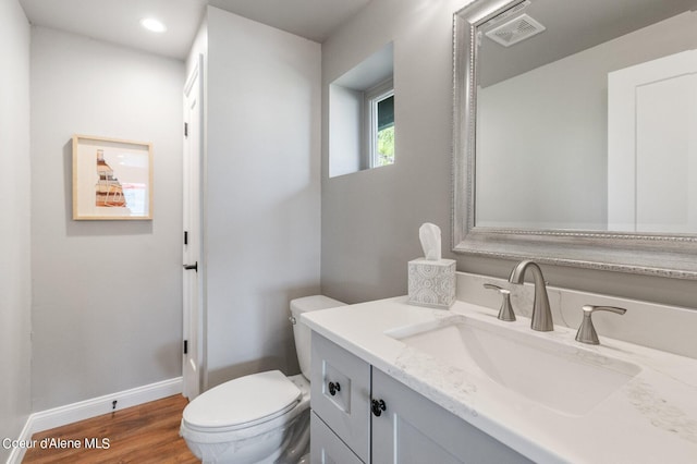 1967 W Cottonwood Rd, Worley, ID 83876 - half bath featuring visible vents, baseboards, toilet, vanity, and wood finished floors