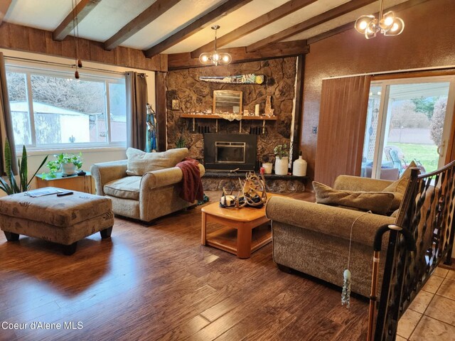 216 W Oak Ave, Osburn, ID 83849 - living area with a fireplace, vaulted ceiling with beams, and wood finished floors