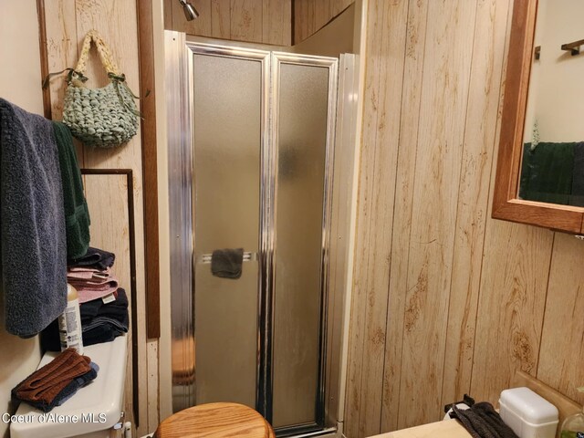 216 W Oak Ave, Osburn, ID 83849 - bathroom featuring a shower stall and wooden walls