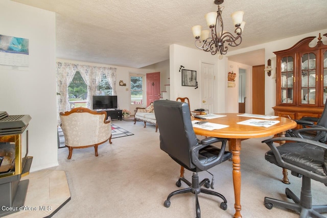 dining space featuring a textured ceiling, an inviting chandelier, and light colored carpet