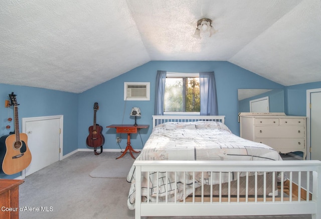 bedroom featuring carpet flooring, a wall mounted air conditioner, a textured ceiling, baseboards, and lofted ceiling