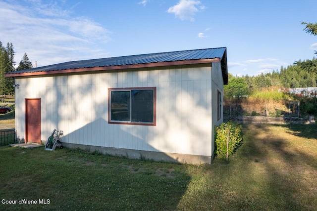 view of property exterior featuring a yard and metal roof